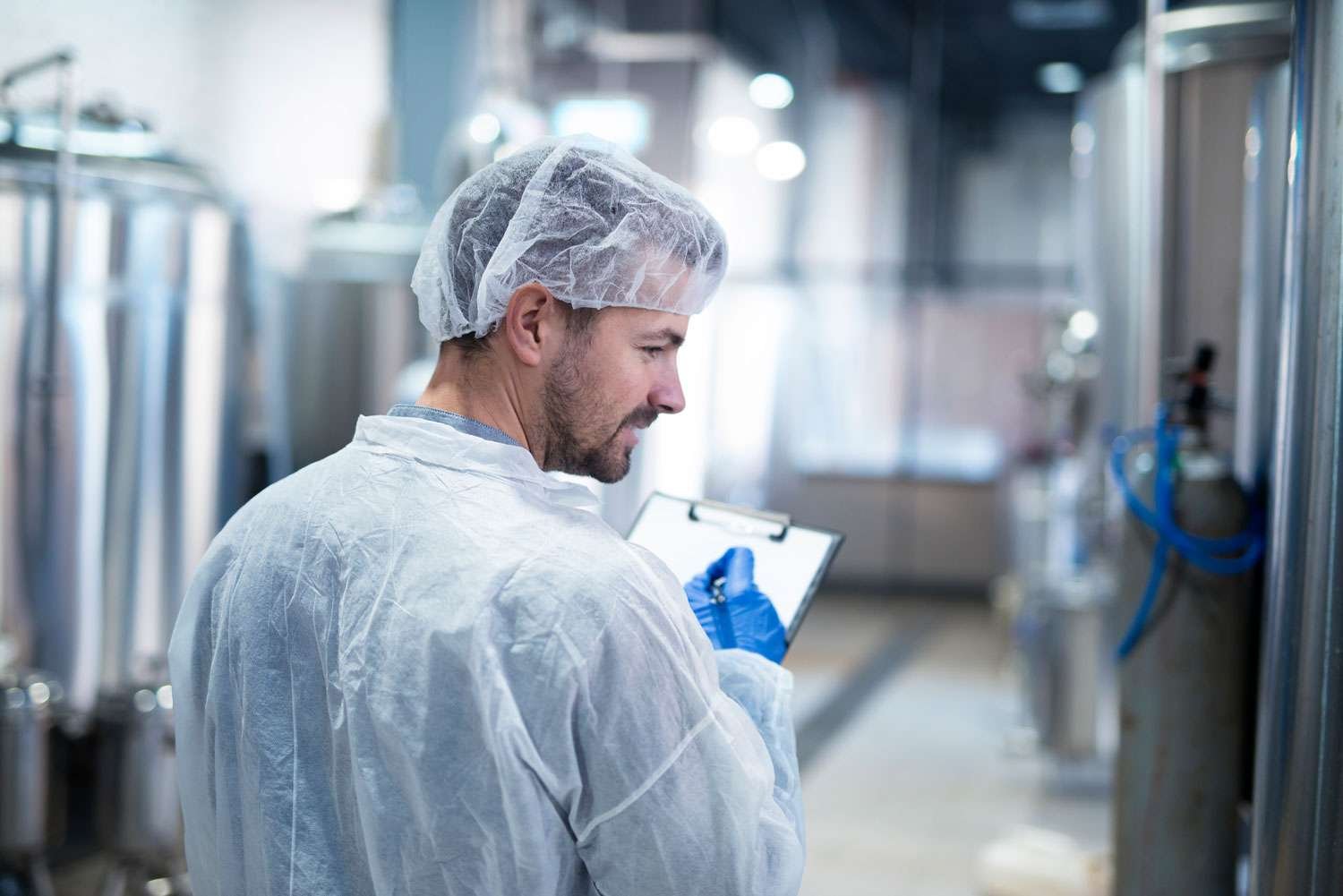A quality-control specialist inspecting production